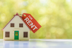 Small toy home with 'for rent' sign
