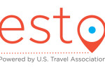 Letters e s t o in orange with the o looking like a destination point, underlined with orange dots. Under that are the words Powered by U.S. Travel Association