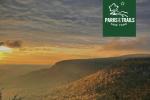 PTNY logo on sunset over Adirondack Mountains
