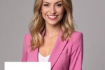 A woman smiling wearing a pink blazer with the Carvertise Logo in the bottom left corner